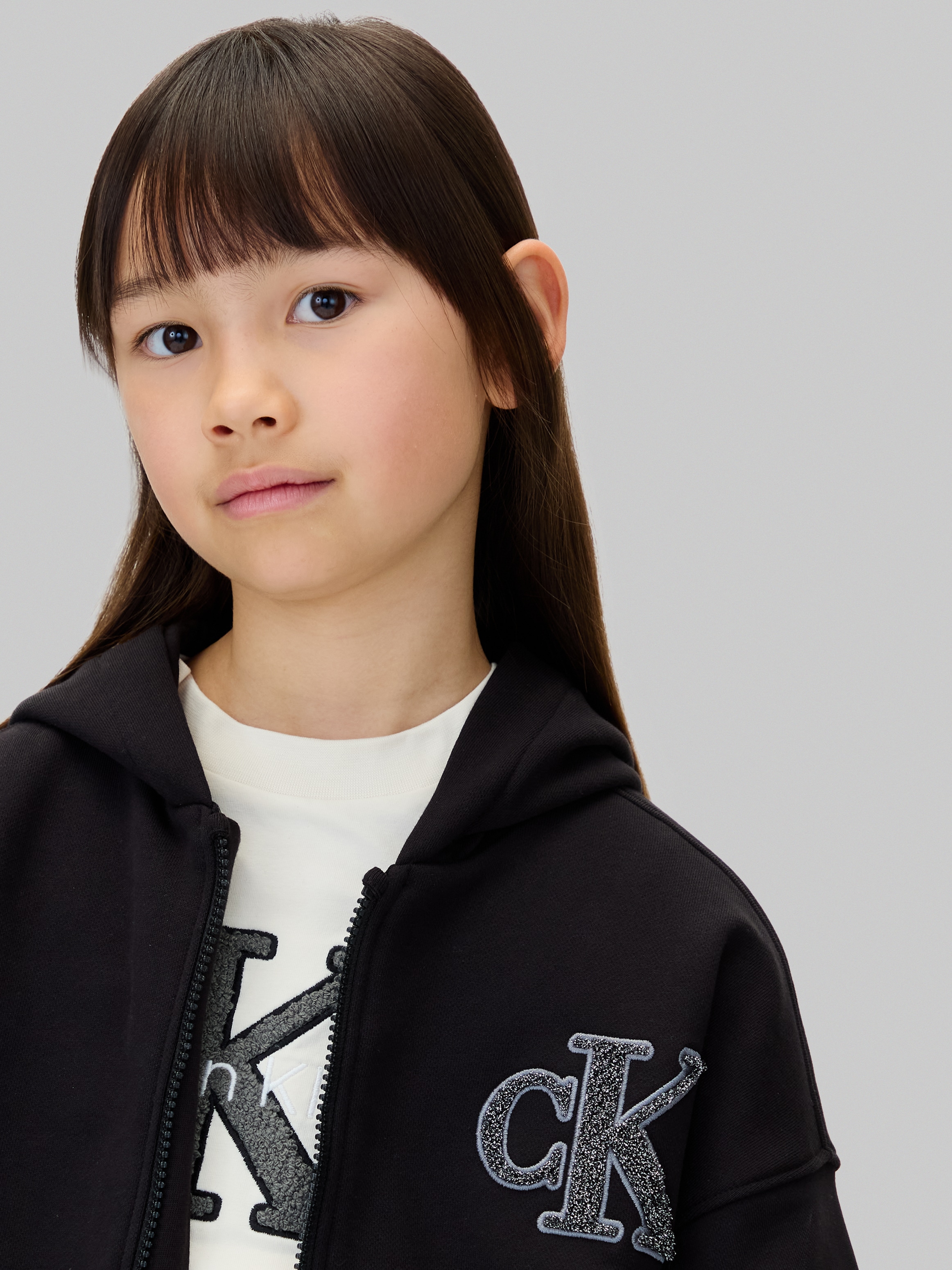 Calvin Klein Jeans Sweatjacke »CK LOGO TERRY ZIP THROUGH«, für Kinder bis 16 Jahre, mit Glitzer-Applikation